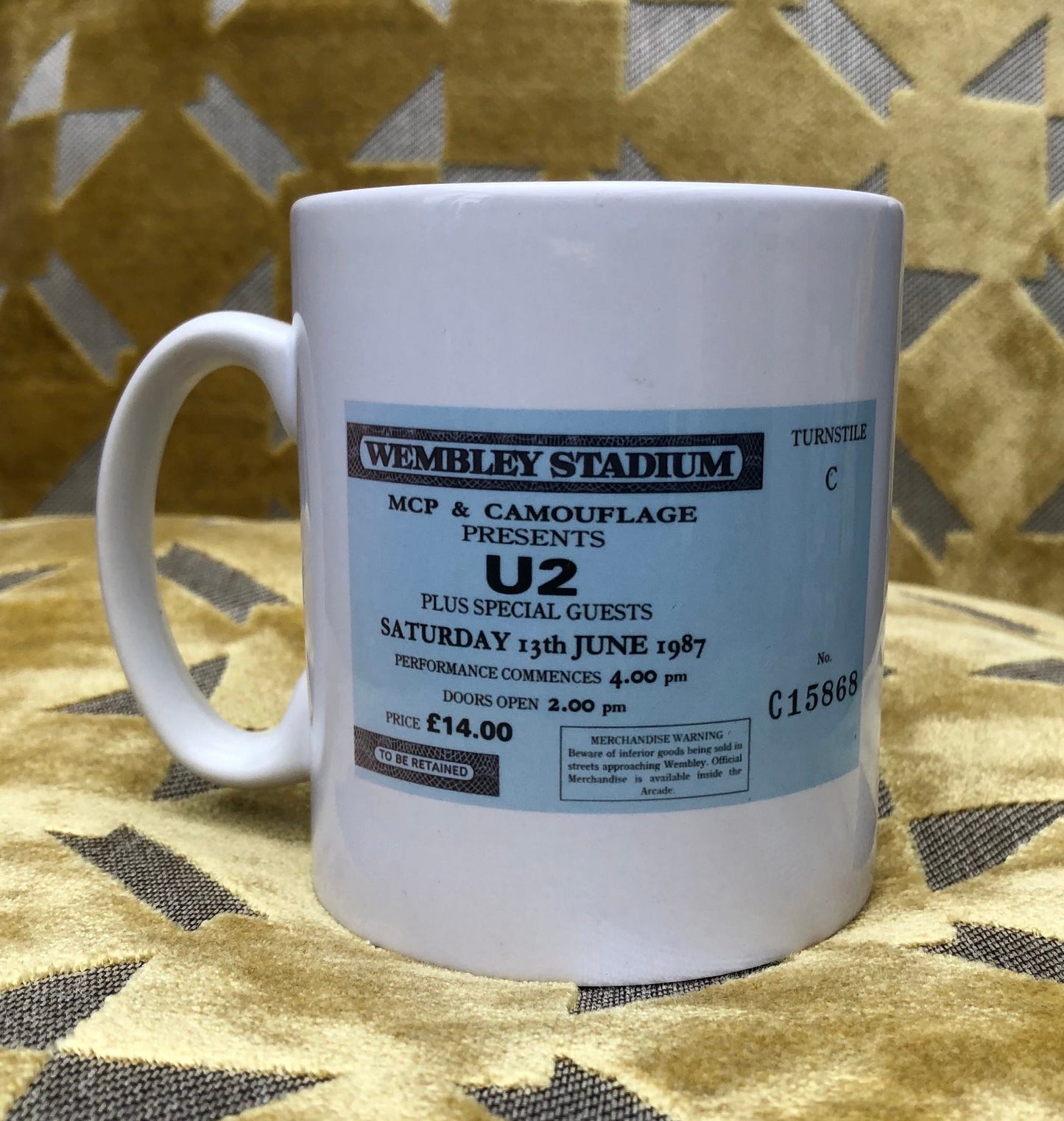 U2 - 11oz ceramic mug featuring the 1987 “ Joshua Tree tour” featuring the Wembley Stadium , London ticket on one side of the mug and the corresponding tour advert on the other side